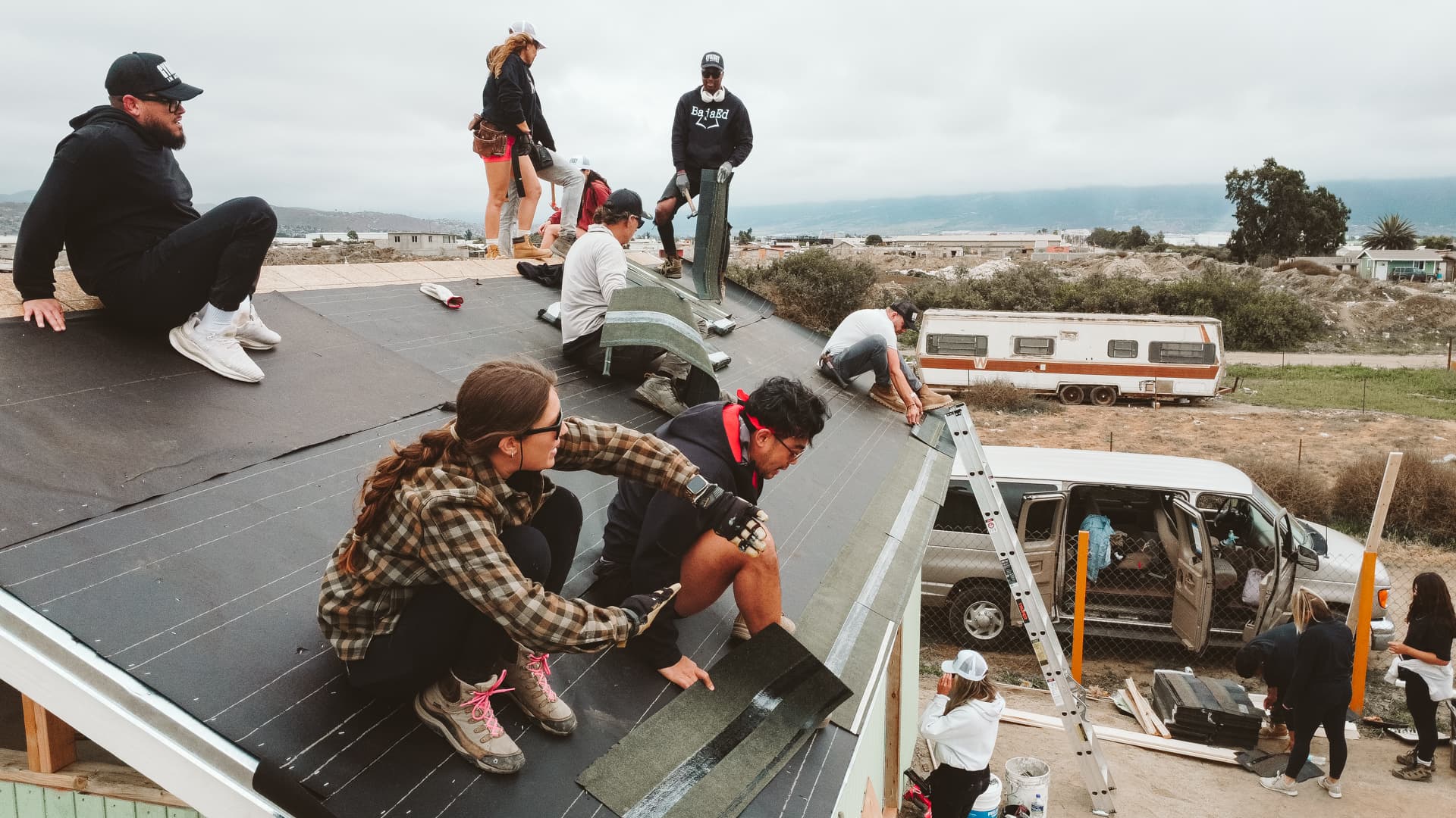 Team building a home together for a family in need