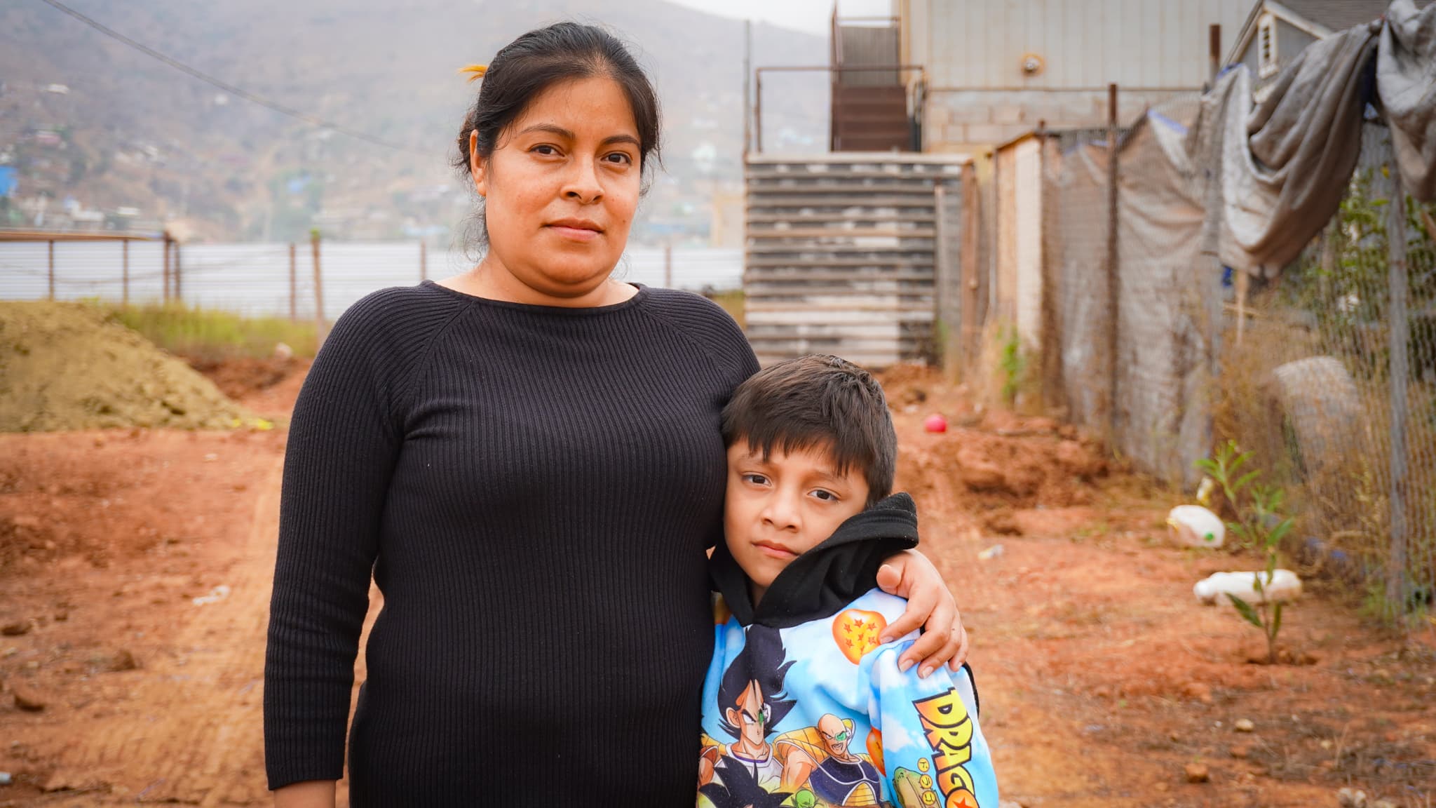 Mother and son of the Pérez Vázquez family at the build site in Ensenada, Mexico